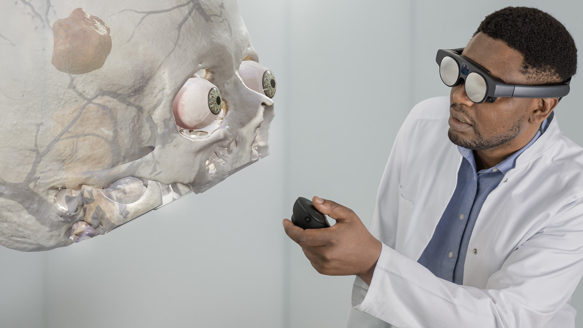 An individual using the Mixed Reality Viewer in an office, examining a cranial image