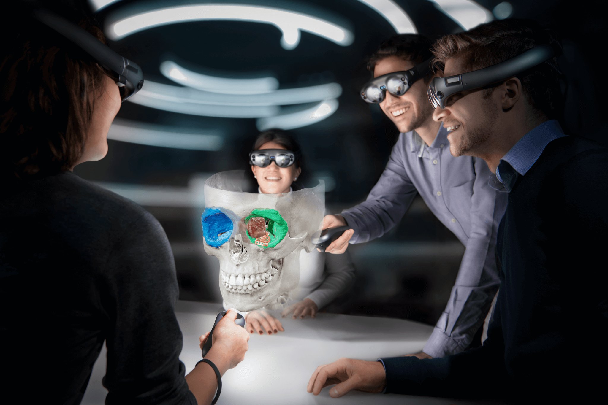 A group of people wearing the Mixed Reality Viewer gather around a table, examining a cranial image