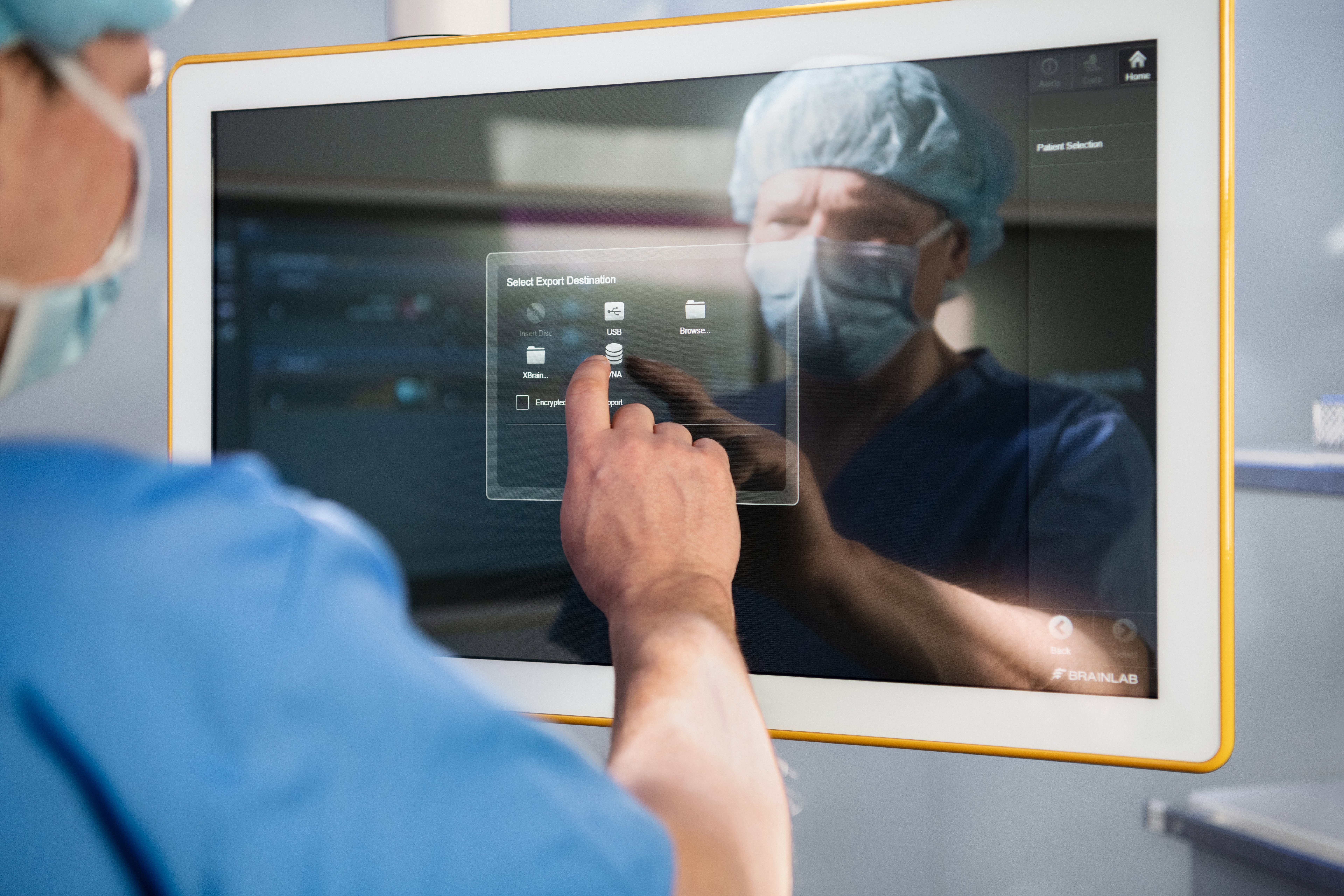 A surgeon archiving data using Brainlab technology in the OR - illustrating the service and support of Brainlab for healthcare IT