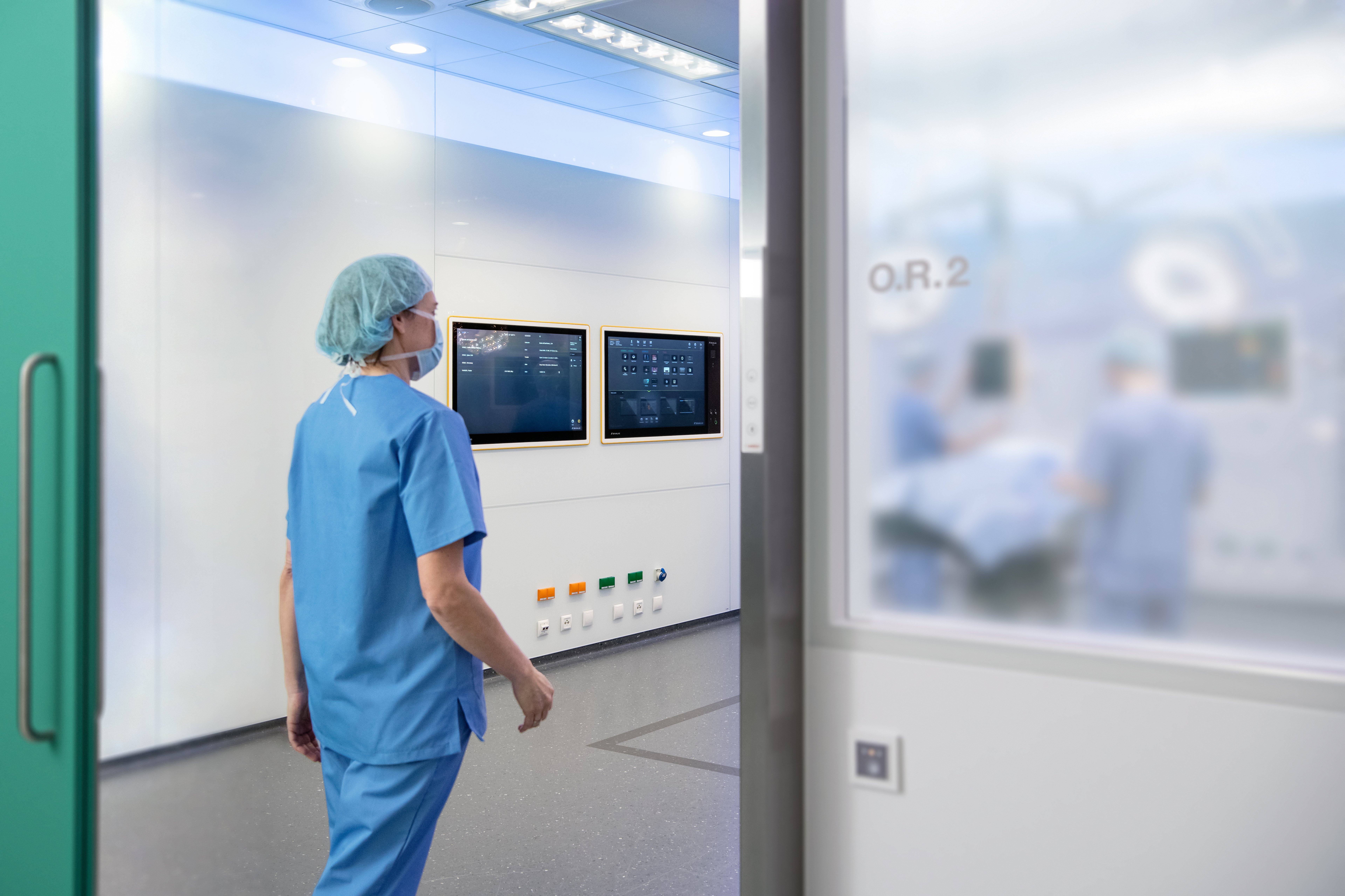 Buzz installed in an operating room is pictured in the background while a surgeon is entering the O.R.